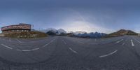 a photo of a view of a street with some mountains in the background in this panorama