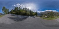 an 360 - view of a skateboarder doing a trick in the mountains and trees