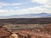 a person is riding their motorcycle up the side of a mountain above an arid area