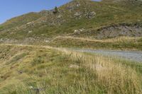 a motorcycle with no rider is going along a mountain side road with rocks on top of it