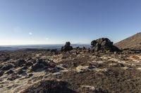 a mountain with some rocks and a blue sky above it's clouds is shown in this landscape