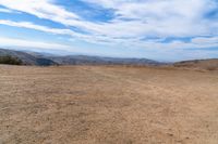 this is an image of some dirt and mountains, and the sky has just gone to full color