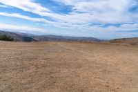 this is an image of some dirt and mountains, and the sky has just gone to full color