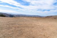 this is an image of some dirt and mountains, and the sky has just gone to full color