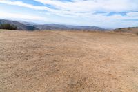 this is an image of some dirt and mountains, and the sky has just gone to full color