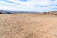 this is an image of some dirt and mountains, and the sky has just gone to full color