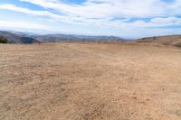 this is an image of some dirt and mountains, and the sky has just gone to full color