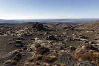 the view from the top of a mountain, with rocky and grassy area in front