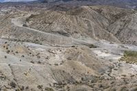 this is a photo of a barren landscape with some mountain side roads that can be seen in the distance