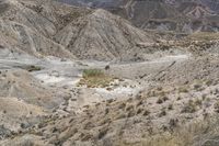 this is a photo of a barren landscape with some mountain side roads that can be seen in the distance