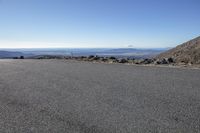 the empty road is full of rocks and a red stop sign that indicates that no car is driving on it