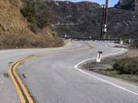 a sign directing drivers to go to and exit the road while traffic is down a hill