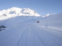 the man is skiing down the snowy mountain side trail in the back ground, blurred with motion