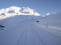 the man is skiing down the snowy mountain side trail in the back ground, blurred with motion