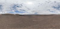 the top of a mountain is seen through a 3d lens camera, with clouds in the background