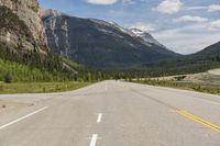 a man with backpack on a mountain road in the mountains in canada's alberta national park