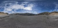 a view from the inside of a fisheye camera lens that shows a mountain road