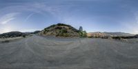 a 360 - spherical view is shown from a road side in the mountains on a sunny day