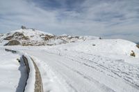 a snowboarder is going down the snow on a steep slope in the mountains