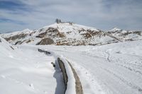 a snowboarder is going down the snow on a steep slope in the mountains