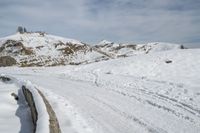 a snowboarder is going down the snow on a steep slope in the mountains