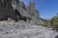 the cliff is tall and has a steep cliff face that looks very high up in the sky