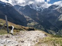 a trail that is going through a mountainous area in mountains with snowcapped peaks