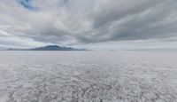 a landscape with some clouds on top of the mountain range in the distance are ice floes