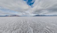 a landscape with some clouds on top of the mountain range in the distance are ice floes