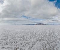 a landscape with some clouds on top of the mountain range in the distance are ice floes