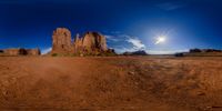 a wide angle view of the mountains near monument valley in utah with an odd lens