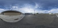 there is a fisheye lens of this parking lot and street scene shot from inside the vehicle