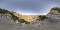 a 360 - lens panoramic picture of the mountaintop above a canyon and cliff