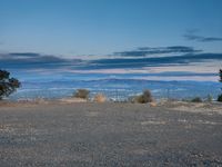 a black fire hydrant in front of a mountainous landscape at sunset on the rim