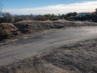 the end of a dirt road in an area that looks to be desert land for a pickup truck