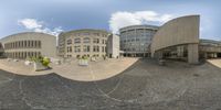 a panoramic view of the outside of a museum and building from the front