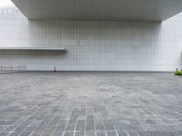 an empty courtyard with the floor empty in a museum, featuring grey cobblestone