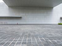 an empty courtyard with the floor empty in a museum, featuring grey cobblestone