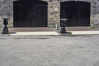 a parking meter on a city sidewalk next to an old brick building with open garage doors