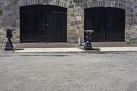 a parking meter on a city sidewalk next to an old brick building with open garage doors