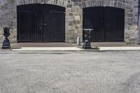 a parking meter on a city sidewalk next to an old brick building with open garage doors