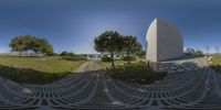 360 view of a circular walkway outside a museum, and park area in front of the monument