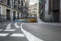 a very narrow street is seen in this photo from the camera's point - view