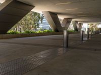 a walkway that looks very narrow and empty with benches outside in it, which has been painted silver