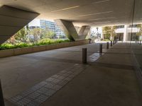 a walkway that looks very narrow and empty with benches outside in it, which has been painted silver