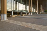 a photo of an empty plaza by a building and stairs with stairs going up, down, and the rest down