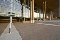 a photo of an empty plaza by a building and stairs with stairs going up, down, and the rest down