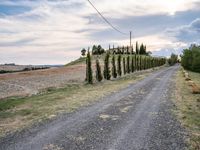 two empty road surrounded by rocks and bushes next to the gravel road that has a small stone walkway