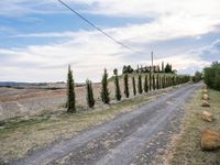 two empty road surrounded by rocks and bushes next to the gravel road that has a small stone walkway