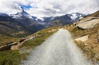 Nature's Glory: Mountain Road in Switzerland Surrounded by Clouds